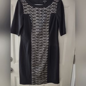 Elegant and modern. Has a classic silhouette with some sheer wavey lace